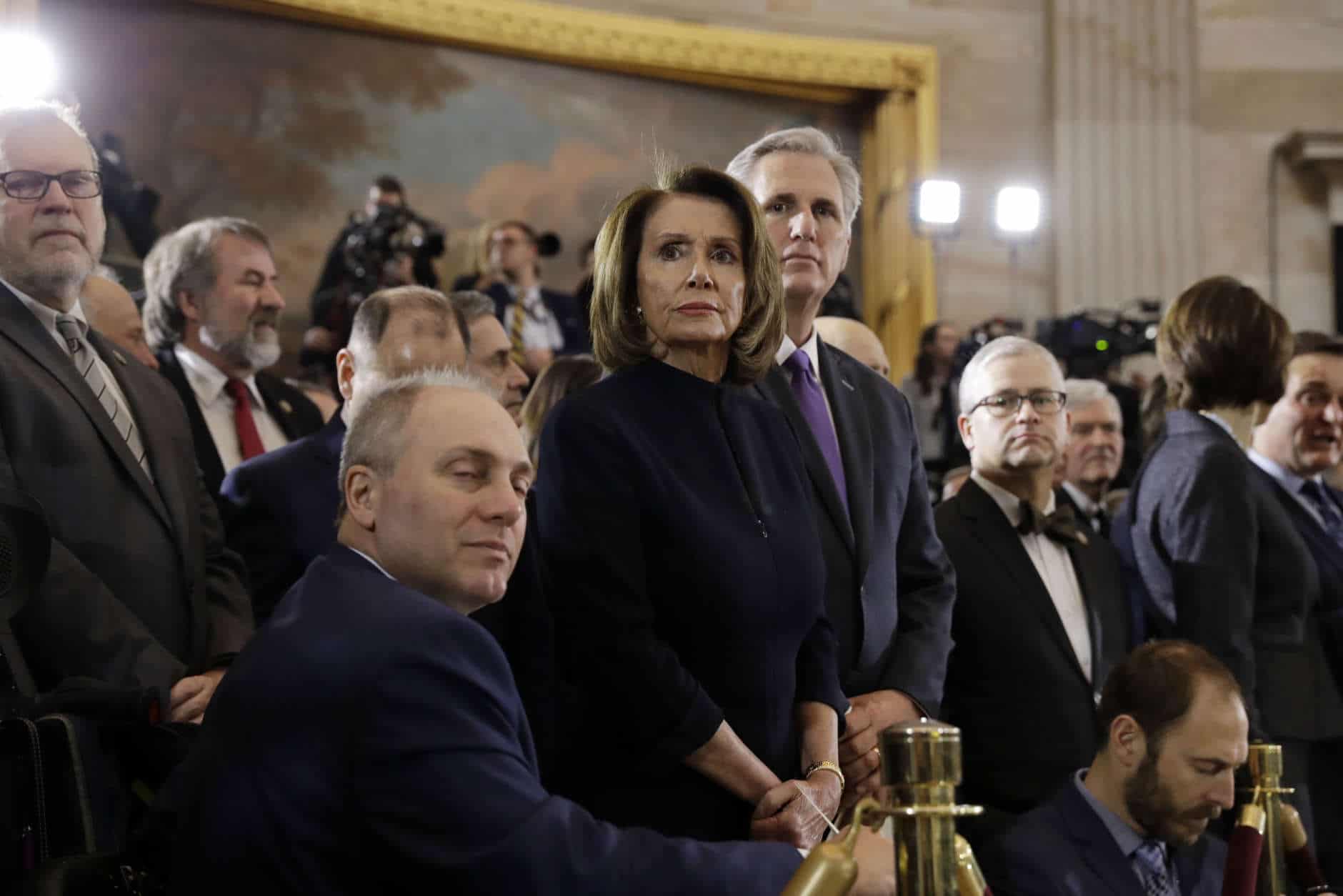 House Majority Whip Steve Scalise, R-La., foreground, House Minority Leader Nancy Pelosi, D-Calif., center and House Majority Leader Kevin McCarthy, R-Calif., right and waits for the ceremony to begin honoring Reverend Billy Graham in the Rotunda of the U.S. Capitol building, Wednesday, Feb. 28, in Washington. (AP Photo/Evan Vucci)