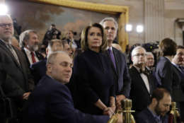 House Majority Whip Steve Scalise, R-La., foreground, House Minority Leader Nancy Pelosi, D-Calif., center and House Majority Leader Kevin McCarthy, R-Calif., right and waits for the ceremony to begin honoring Reverend Billy Graham in the Rotunda of the U.S. Capitol building, Wednesday, Feb. 28, in Washington. (AP Photo/Evan Vucci)