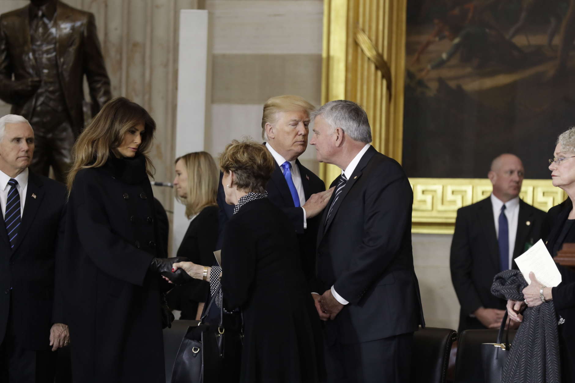 President Donald Trump, center, greets Franklin Graham, as he arrives for the ceremony honoring his father, the Reverend Billy Graham, in the Rotunda of the U.S. Capitol building, Wednesday, Feb. 28, in Washington. (AP Photo/Evan Vucci)