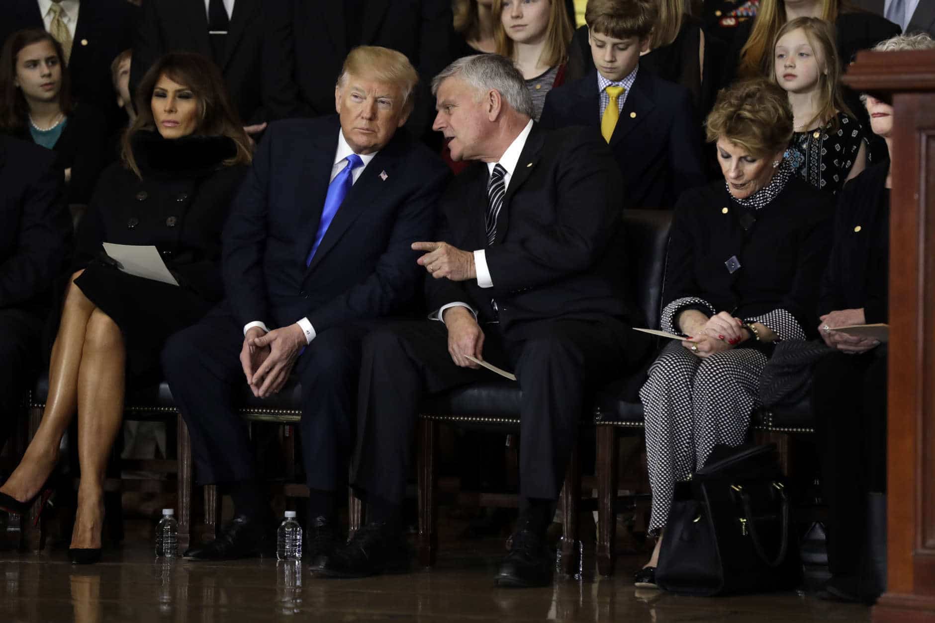President Donald Trump talks to Franklin Graham during a ceremony honoring Reverend Billy Graham in the Rotunda of the U.S. Capitol building, Wednesday, Feb. 28, in Washington. (AP Photo/Evan Vucci)