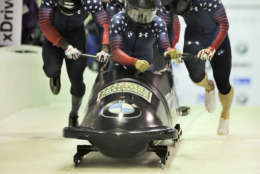Driver Elana Taylor Meyers with Alex Harrison, Nicholas Taylor and brakeman Hakeem Abdul-Saboor, of the United States Exhibition team,
take part in the four-man bobsled World Cup race on Saturday, Dec. 17, 2016, in Lake Placid, N.Y. (AP Photo/Hans Pennink)