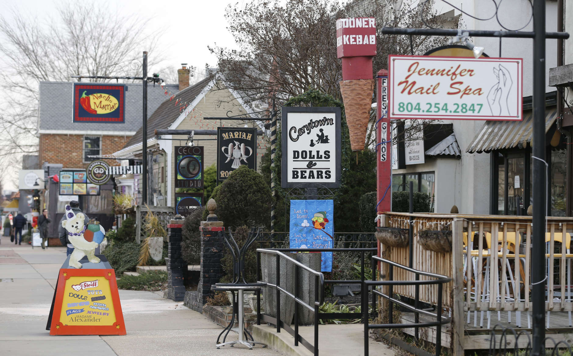 In this Jan. 20, 2016 photo, various shops line the street in Carytown a quaint neighborhood a few miles west of downtown Richmond, Va. Restaurants offer a range of ethnic cuisine and clothing stores range from formalwear to second-hand shops.  (AP Photo/Steve Helber)