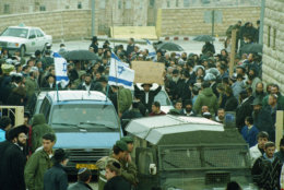 The funeral procession of Dr. Baruch Goldstein leaves a funeral home in Jerusalem en route to a burial site near Hebron, on the Israeli occupied West Bank, Feb. 27, 1994.  Goldstein, a Jewish settler, opened fire on Muslims praying in the Ibrahim Mosque at the Tomb of the Patriarchs in Hebron on Friday, killing at least 39 people before being overpowered and killed by the worshipers.  The killings sparked violence throught Israel and the occupied lands.  (AP Photo/Eyal Warsharsky)