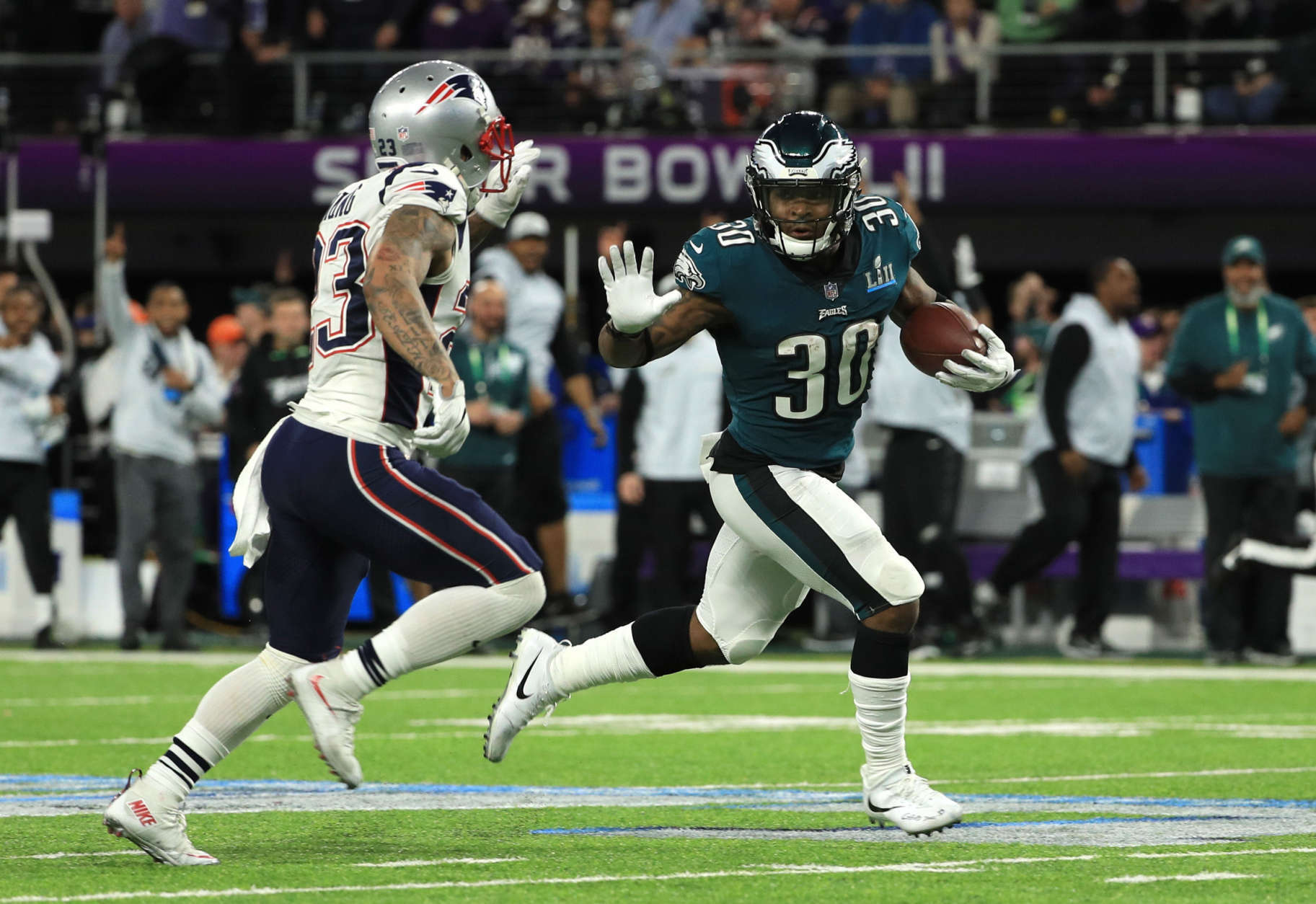 MINNEAPOLIS, MN - FEBRUARY 04:  Corey Clement #30 of the Philadelphia Eagles pushes off a tackle from Patrick Chung #23 of the New England Patriots during the second quarter in Super Bowl LII at U.S. Bank Stadium on February 4, 2018 in Minneapolis, Minnesota.  (Photo by Mike Ehrmann/Getty Images)