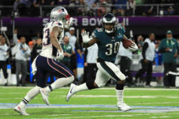 MINNEAPOLIS, MN - FEBRUARY 04:  Corey Clement #30 of the Philadelphia Eagles pushes off a tackle from Patrick Chung #23 of the New England Patriots during the second quarter in Super Bowl LII at U.S. Bank Stadium on February 4, 2018 in Minneapolis, Minnesota.  (Photo by Mike Ehrmann/Getty Images)