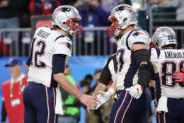 MINNEAPOLIS, MN - FEBRUARY 04:  Tom Brady #12 and Rob Gronkowski #87 of the New England Patriots celebrate a 5-yard touchdown against the Philadelphia Eagles in the third quarter of Super Bowl LII at U.S. Bank Stadium on February 4, 2018 in Minneapolis, Minnesota.  (Photo by Elsa/Getty Images)