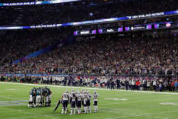 MINNEAPOLIS, MN - FEBRUARY 04:  the New England Patriots and Philadelphia Eagles huddle during the fourth quarter of Super Bowl LII at U.S. Bank Stadium on February 4, 2018 in Minneapolis, Minnesota.  (Photo by Streeter Lecka/Getty Images)