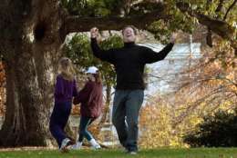 WASHINGTON, :  US Vice President Al Gore (R) celebrates scoring a touchdown as daughters Kristin (C) and Karenna (L) walk away during a touch football game with family members 10 November 2000 at the Vice President's residence in Washington, DC. Gore and Texas Governor George W. Bush are still waiting for results of the Florida vote count to determine the next US president.   AFP PHOTO/Joyce NALTCHAYAN (Photo credit should read JOYCE NALTCHAYAN/AFP/Getty Images)
