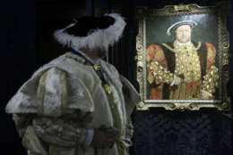 Costumed interpreter Richard Evans, as Britain's King Henry VIII, poses for photographs beside a close copy of a portrait painted during Henry's reign by the German artist Hans Holbein, at Hampton Court Palace, on the outskirts of London, Thursday, April 9, 2009.  The original painting did not survive, with this copy painting being made around 1540 by an artist in the circle of Hans Holbein.  During 2009, King Henry VIII's most famous royal residence plays host to 'Henry VIII: heads and hearts' a year-long programme of events and celebratory activities to mark the Tudor monarch's accession to the throne.  (AP Photo/Matt Dunham)