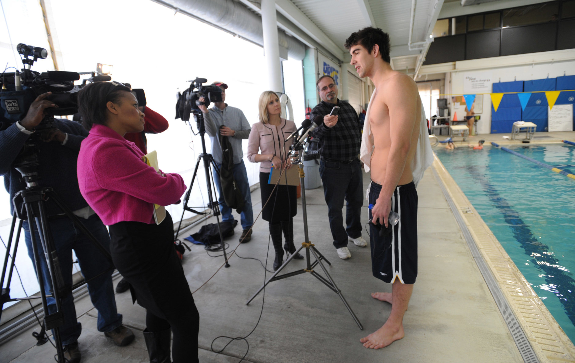 Olympic gold medalist Michael Phelps answers questions from reporters before training at the Meadowbrook Aquatic Center, Friday, Feb. 6, 2009, in Baltimore. The swimming superstar has been suspended for three months and had his training stipend revoked by USA Swimming. (AP Photo/Gail Burton)