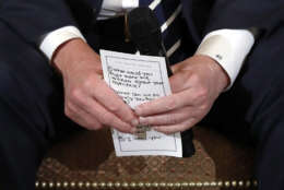 President Donald Trump holds notes during a listening session with high school students and teachers in the State Dining Room of the White House in Washington, Wednesday, Feb. 21, 2018. Trump  heard the stories of students and parents affected by school shootings, following last week's deadly shooting in Florida. (AP Photo/Carolyn Kaster)