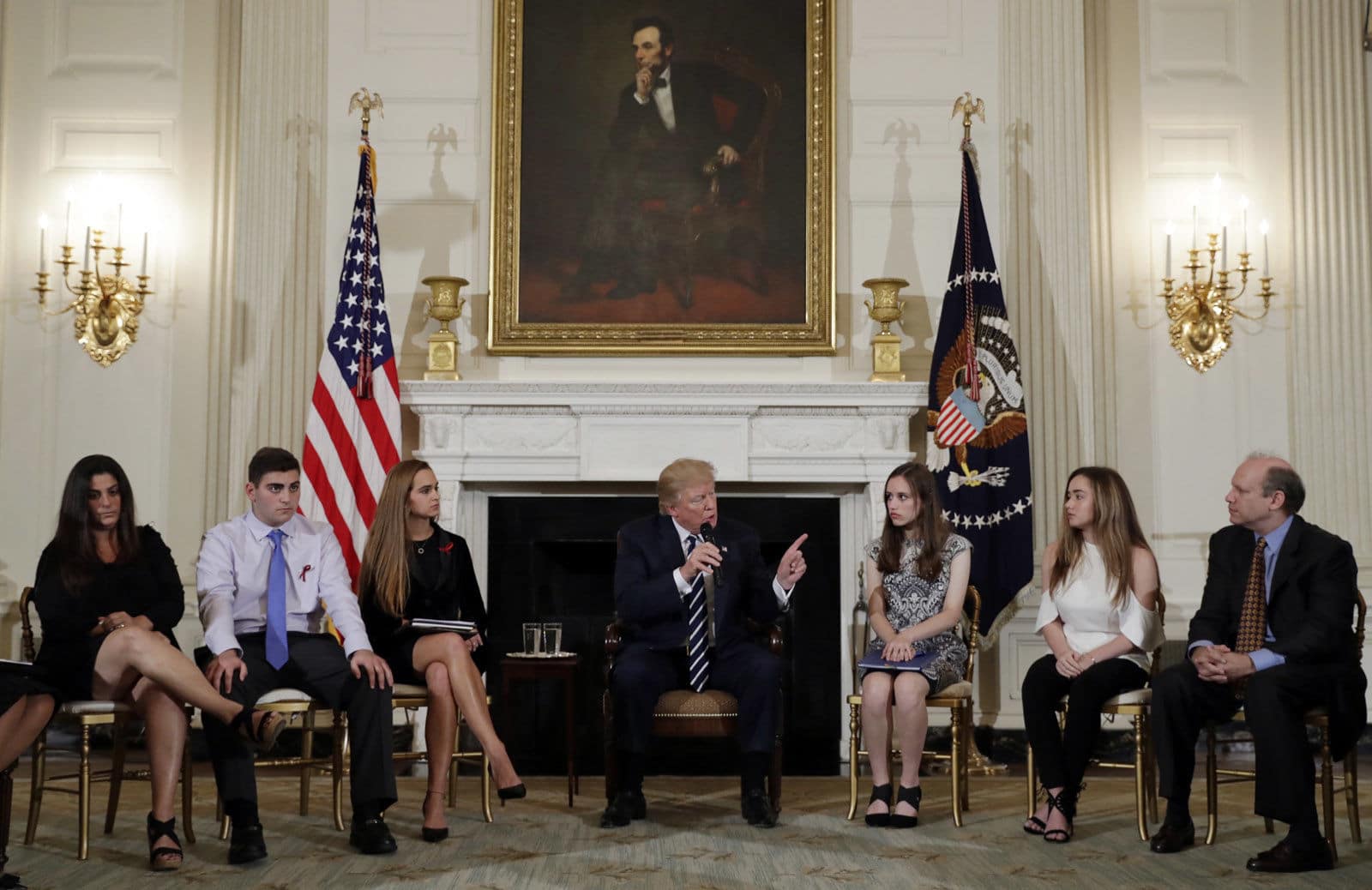 President Donald Trump speaks as he hosts a listening session with high school students, teachers and parents in the State Dining Room of the White House in Washington, Wednesday, Feb. 21, 2018. (AP Photo/Carolyn Kaster)