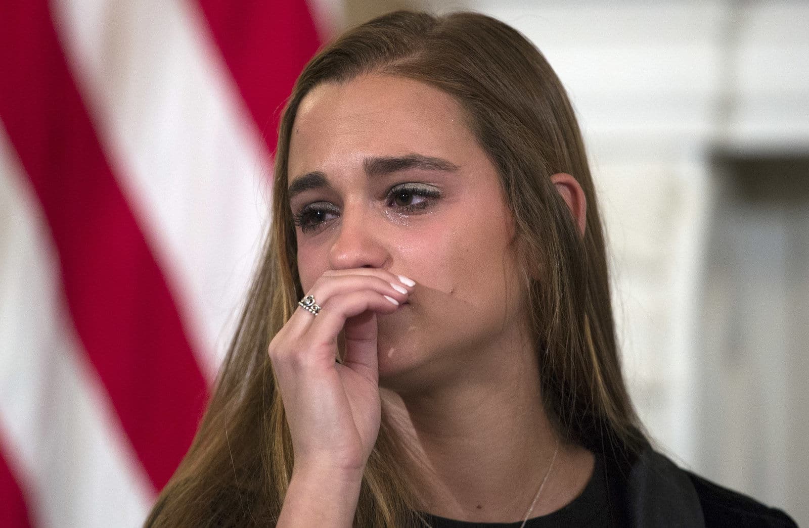 Julia Cordover, the student body president at Marjory Stoneman Douglas High School in Parkland, Fla., cries during listening session with high school students and teachers and President Donald Trump in the State Dining Room of the White House in Washington, Wednesday, Feb. 21, 2018. (AP Photo/Carolyn Kaster)