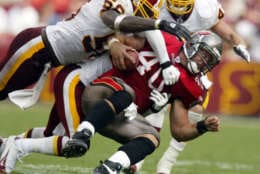 Tampa Bay Buccaneers running back Mike Alstott is stopped by a group of Washington Redskins defenders led by linebacker LaVar Arrington, left, during the second half Sunday, Sept. 12, 2004, in Landover, Md. The Redskins won, 16-10. (AP Photo/Evan Vucci)