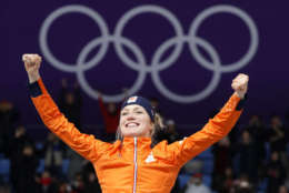 Gold medallist Carlijn Achtereekte of The Netherlands jumps for joy during the flower ceremony of the women's 3,000 meters race at the Gangneung Oval at the 2018 Winter Olympics in Gangneung, South Korea, Saturday, Feb. 10, 2018. (AP Photo/John Locher)