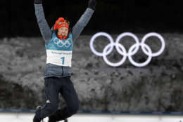 Gold medalist Laura Dahlmeier, of Germany, leaps in the air during the venue ceremony at the women's 10-kilometer biathlon pursuit at the 2018 Winter Olympics in Pyeongchang, South Korea, Monday, Feb. 12, 2018. (AP Photo/Andrew Medichini)