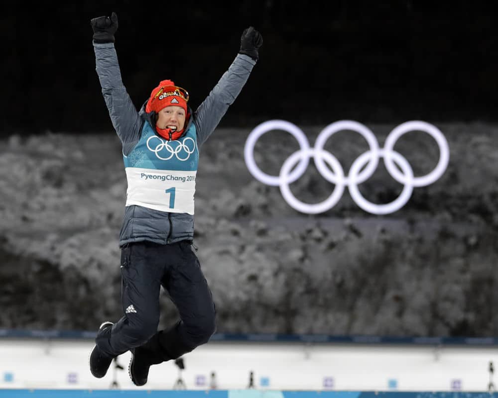 Gold medalist Laura Dahlmeier, of Germany, leaps in the air during the venue ceremony at the women's 10-kilometer biathlon pursuit at the 2018 Winter Olympics in Pyeongchang, South Korea, Monday, Feb. 12, 2018. (AP Photo/Andrew Medichini)