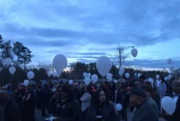 Mourners release white balloons during a vigil Wednesday, Feb. 28, 2018, for Prince George's County police officer Mujahid Ramzziddin, who was killed while helping a neighbor. (WTOP/Dick Uliano)