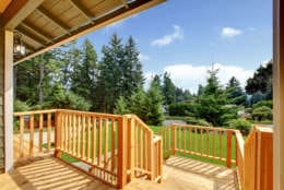 Wooden walkout deck with patio area overlooking backyard. Northwest, USA
