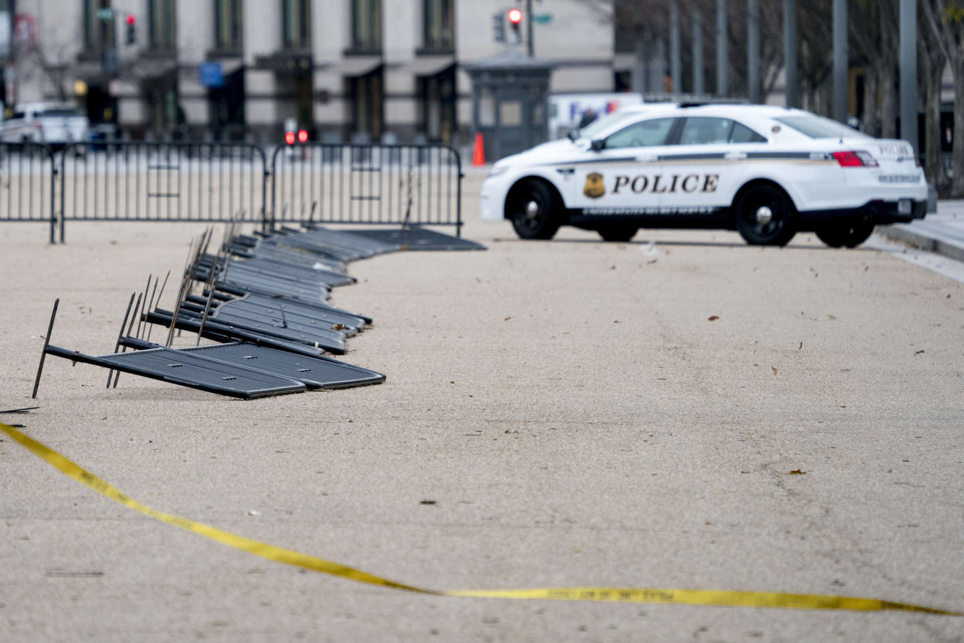 Barricade fencing is knocked over in front of the White House on Pennsylvania Avenue as the region experiences high winds, Friday, March 2, 2018 in Washington. (AP Photo/Andrew Harnik)