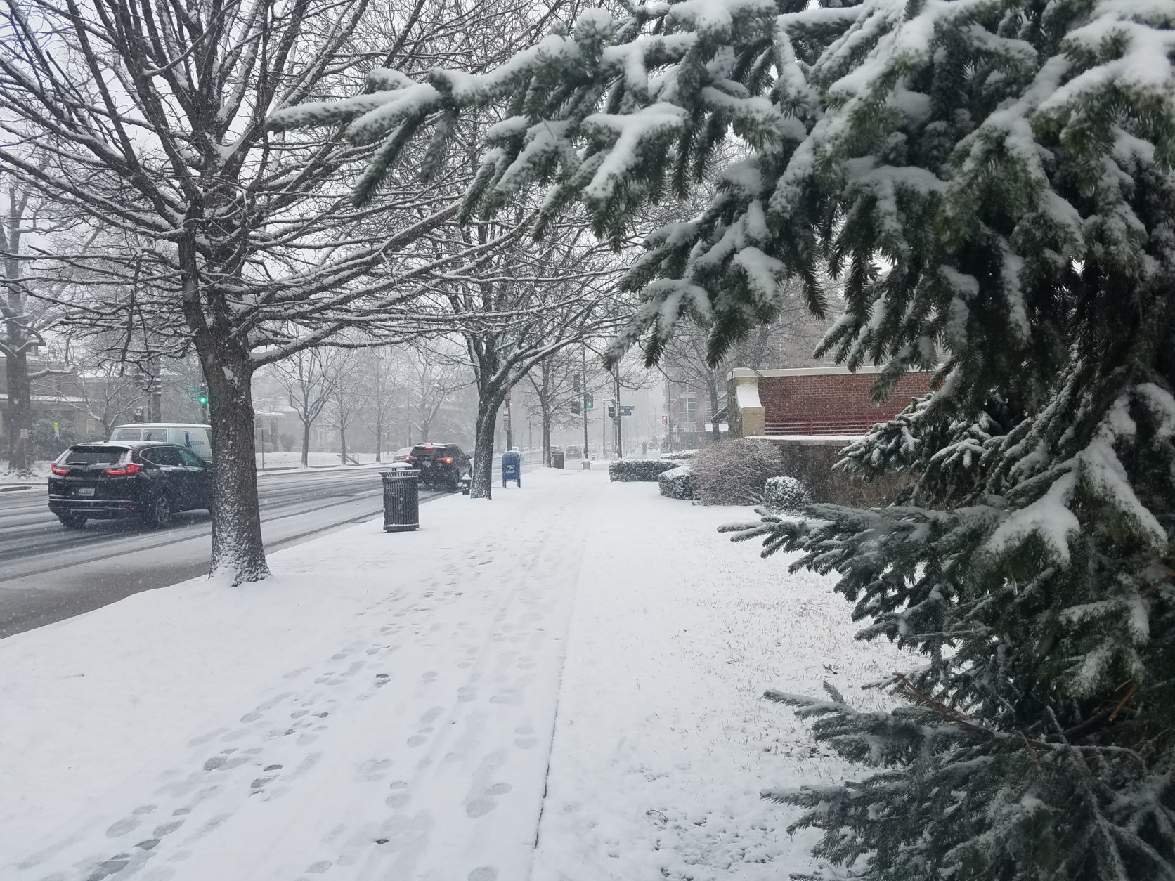 Roads and sidewalks are slick from snow and slush Wednesday morning. (WTOP/William Vitka)