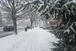 Roads and sidewalks are slick from snow and slush Wednesday morning. (WTOP/William Vitka)
