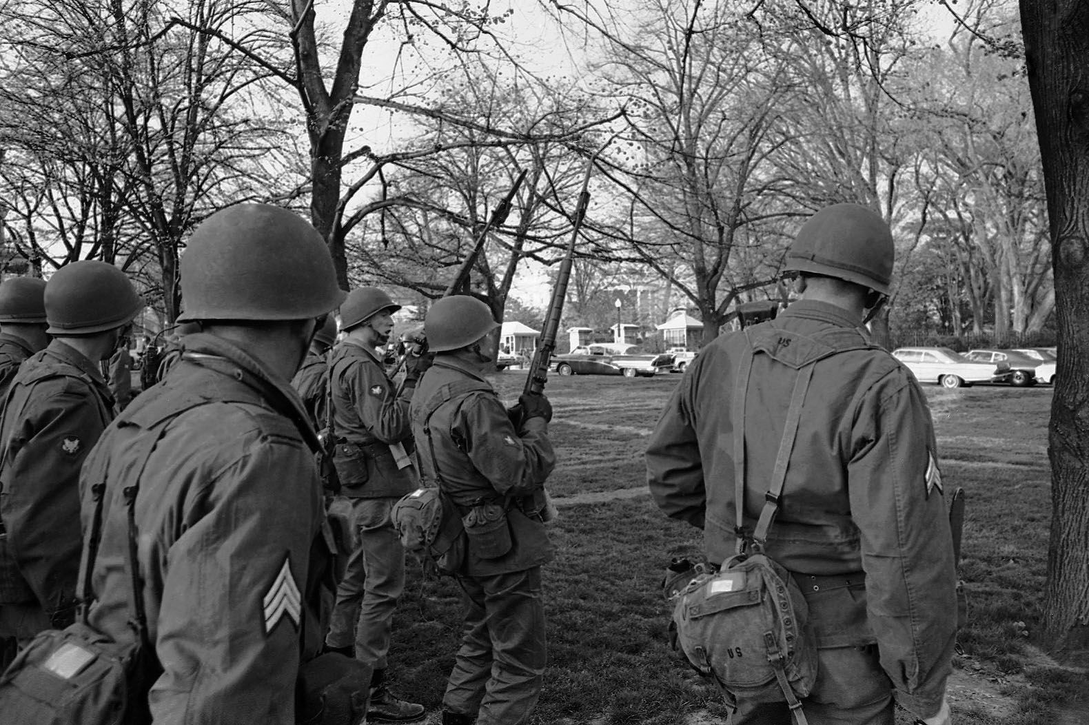 Soldiers of the 3rd Infantry Regiment from Fort Myer, Va., take up posts in Lafayette Park near the White House in background on April 5, 1968. They were part of the Federal troops ordered into the nation's capital by President Lyndon Johnson as looting and burning flared in the downtown area. (AP Photo/Henry Burroughs)