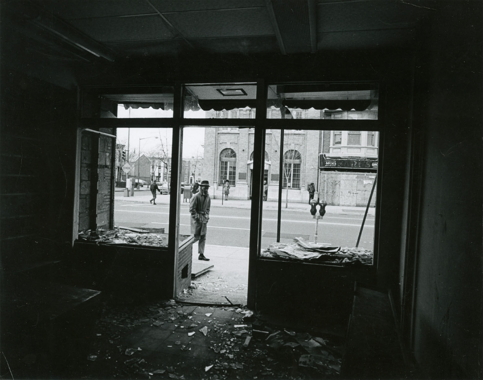 Broken windows and shattered glass in a battered store. Reprinted with permission of the DC Public Library, Star Collection, © Washington Post.