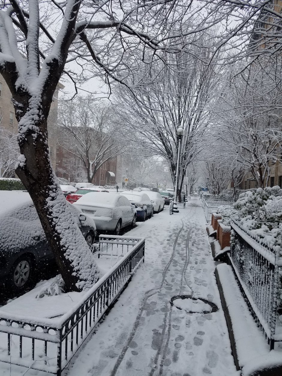 Snow covered sidewalks and cars along 17th Street NW.  (WTOP/Lisa Weiner)