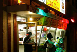 **FILE** In this file photo from Thursday, Aug. 23, 2007, customers exit Ben's Chili Bowl on U Street Northwest in Washington. (AP Photo/Jacquelyn Martin)