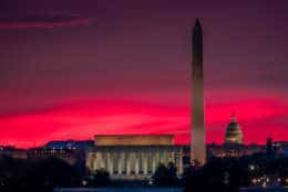 The sunrise behind the skyline of Washington turns the sky red on the first day of daylight saving time in 2017. (AP Photo/J. David Ake)