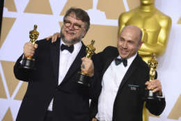 Guillermo del Toro, left, winner of the awards for best director for "The Shape of Water" and best picture for "The Shape of Water", and J. Miles Dale, winner of the award for best picture for "The Shape of Water", pose in the press room at the Oscars on Sunday, March 4, 2018, at the Dolby Theatre in Los Angeles. (Photo by Jordan Strauss/Invision/AP)