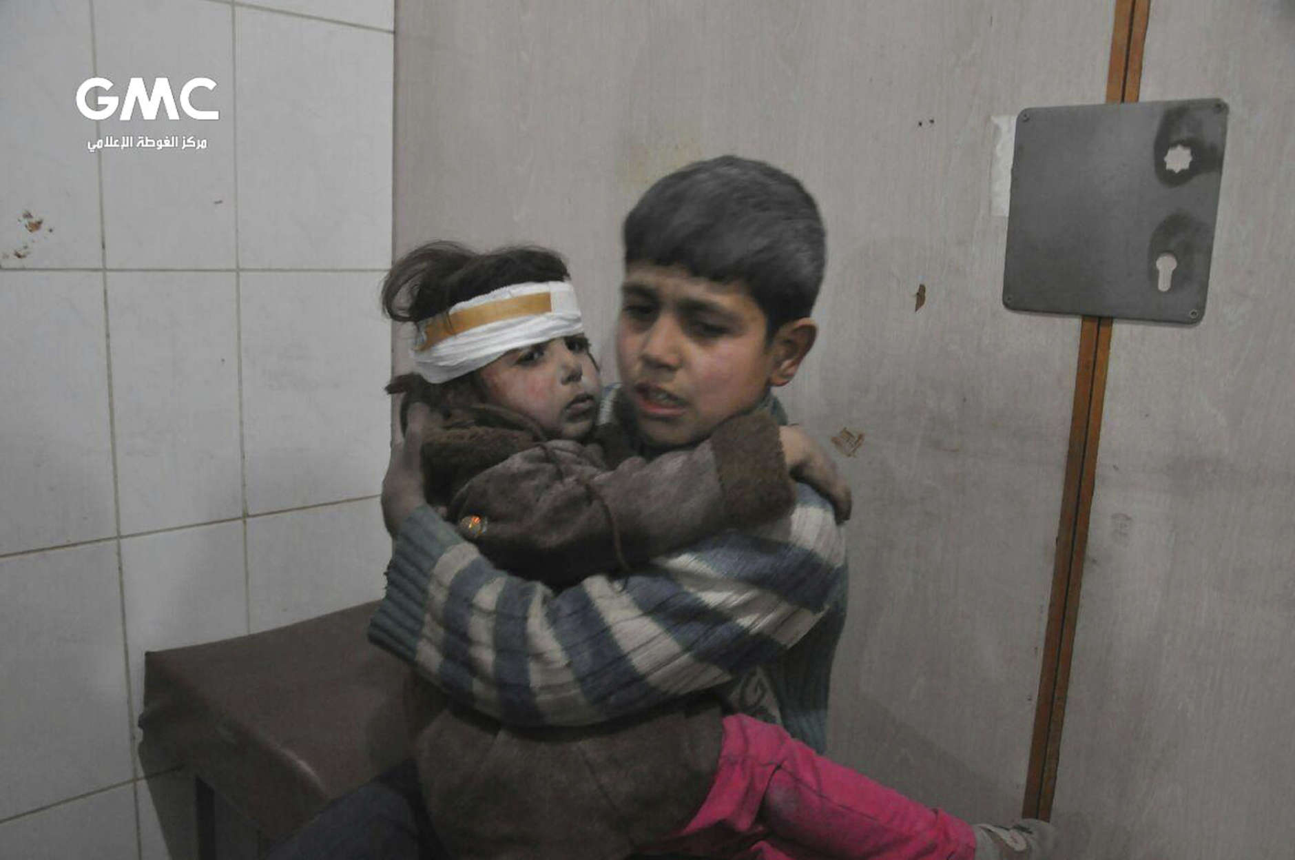 FILE - This file photo released Feb. 21, 2018 provided by the Syrian anti-government activist group Ghouta Media Center, shows two Syrian children who were wounded during airstrikes and shelling by Syrian government forces, at a makeshift hospital, in Ghouta, a suburb of Damascus, Syria. After seven years of war in Syria, the United Nations has one thing to say: Stop the war on children. Of Syria’s estimated 10 million children, 8.6 million are now in dire need of assistance. While the U.N. has verified about 2,500 children killed between 2014 and 2017, it says the actual numbers are much higher. (Ghouta Media Center via AP, File)