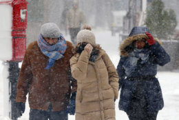Pedestrians make their way through blowing snow during a snowstorm, Tuesday, March 13, 2018, in Boston. (AP Photo/Michael Dwyer)