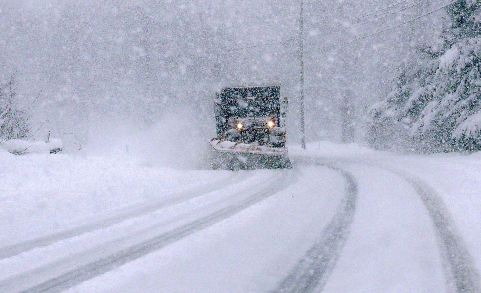 As heavy snow falsl, a plow truck clears Route 102 during a winter storm in Chester, N.H., Tuesday, March 13, 2018. The nor'easter is expected to deliver up to 2 feet of snow to some areas of New England, bringing blizzard conditions to parts of coastal Massachusetts and covering highways with snow. (AP Photo/Charles Krupa)