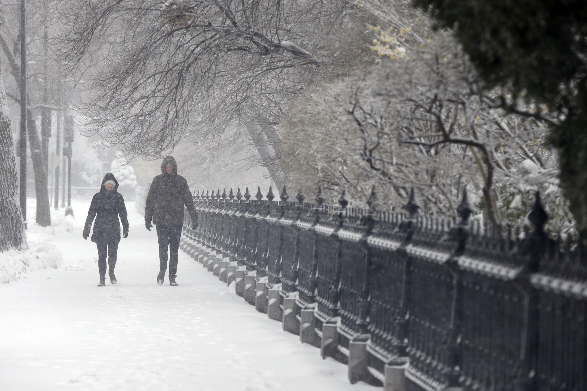 A couple walks during a snowstorm, Tuesday, March 13, 2018, in Boston. (AP Photo/Michael Dwyer)