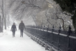 A couple walks during a snowstorm, Tuesday, March 13, 2018, in Boston. (AP Photo/Michael Dwyer)