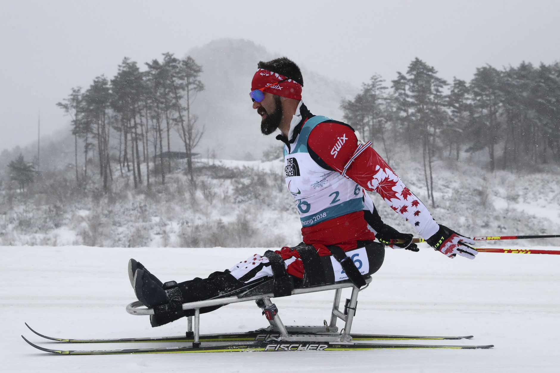 Collin Cameron of Canada competes in the Biathlon Men's 15km Sitting event during the 2018 Winter Paralympics at the Alpensia Biathlon Centre in Pyeongchang, South Korea, Friday, March 16, 2018. (AP Photo/Ng Han Guan)