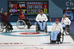 China's Liu Wei, left and Wang Meng, second from left celebrate defeating Norway's Sissel Loechen, right; Rune Lorensten, second from right and Ole Frederik Syversen, third from right during the Wheelchair Curling gold medal match for the 2018 Winter Paralympics at the Gangneung Curling Centre in Gangneung, South Korea, Saturday, March 17, 2018.(AP Photo/Ng Han Guan)