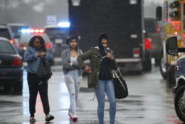 Two students and a mother leave Great Mills High School, the scene of a shooting, Tuesday morning, March 20, 2018 in Great Mills, Md. The shooting left at least three people injured including the shooter. (AP Photo/Alex Brandon  )