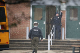 A policeman gives a thumbs-up after moving students into a different area of Great Mills High School, the scene of a shooting, Tuesday morning, March 20, 2018 in Great Mills, Md.  (AP Photo/Alex Brandon  )