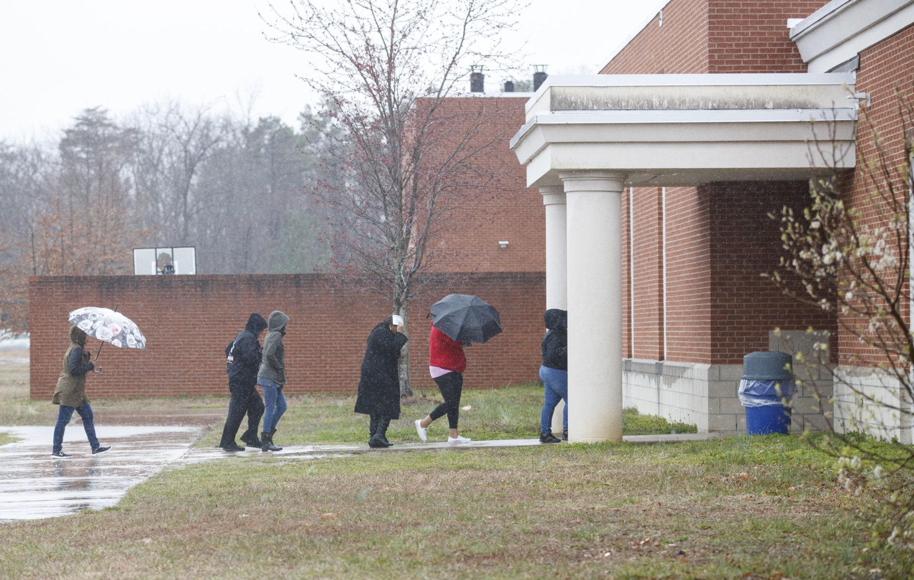 Parents arrive to pick up their children, students from Great Mills High School, at Leonardtown High School in Leonardtown, Md., Tuesday, March 20, 2018.  A teenager wounded a girl and a boy inside his Maryland high school Tuesday before a school resource officer was able to intervene, and each of them fired one more round as the shooter was fatally wounded, a sheriff said. St. Mary's County Sheriff Tim Cameron said the student with the handgun was declared dead at a hospital, and the other two students were in critical condition. (AP Photo/Carolyn Kaster)