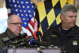 St. Mary's County Sheriff Tim Cameron, right, steps aside as Maryland Gov. Larry Hogan, left, begins to speak about the shooting at Great Mills High School during a news conference in Great Mills, Md., Tuesday, March 20, 2018. (AP Photo/Susan Walsh)