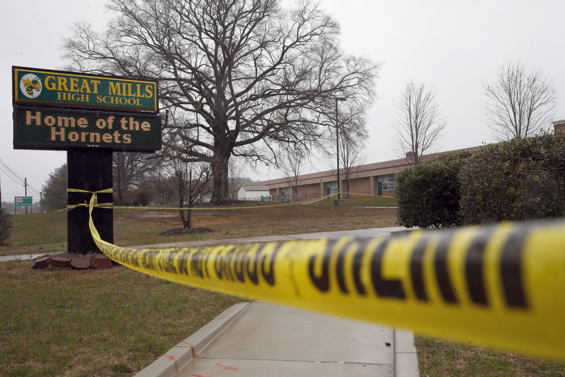 Crime scene tape is used around Great Mills High School, the scene of a shooting, Tuesday, March 20, 2018, in Great Mills. A student with a handgun shot two classmates inside the school before he was fatally wounded during a confrontation with a school resource officer, a sheriff said. (AP Photo/Alex Brandon)