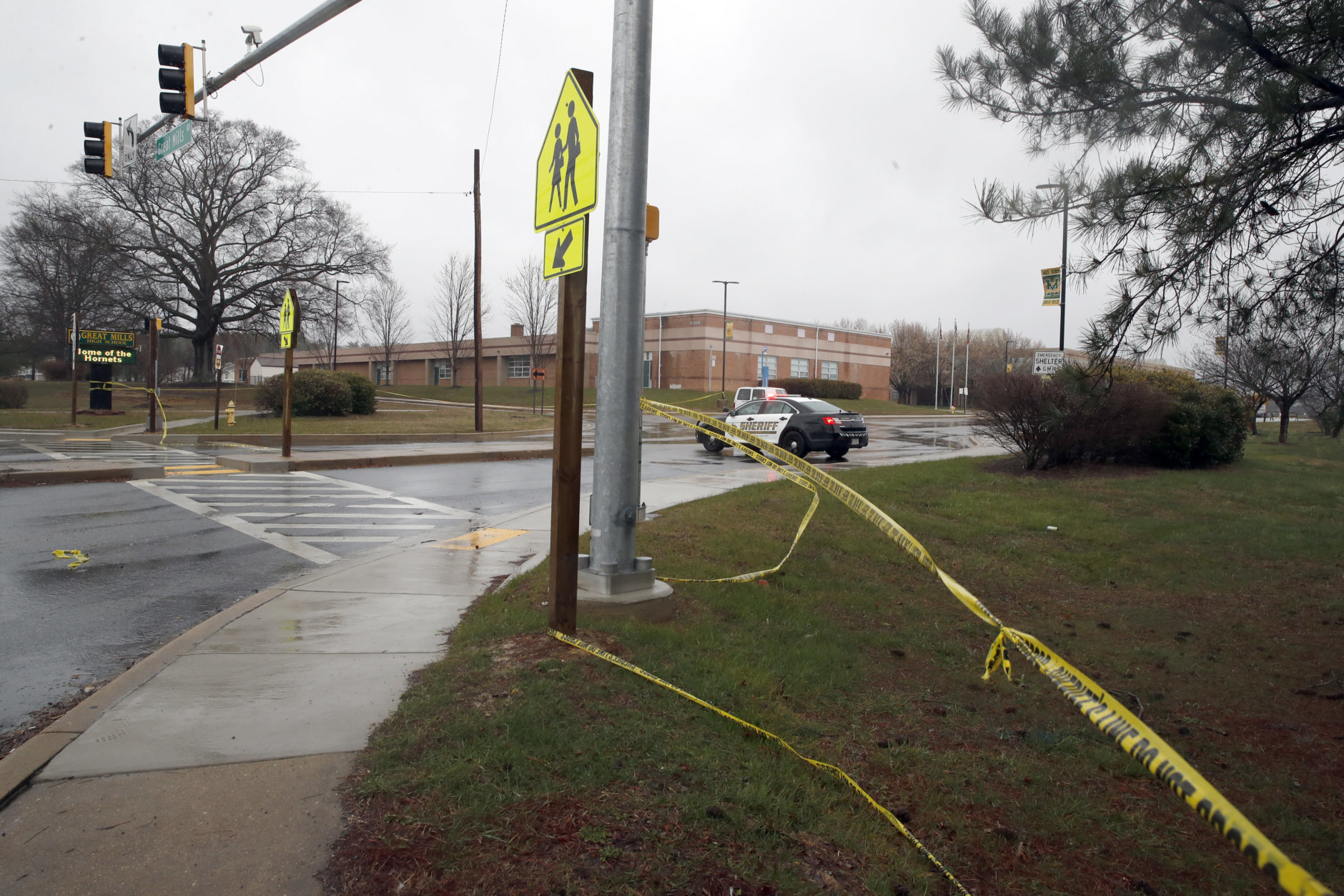 Crime scene tape is used around Great Mills High School, the scene of a shooting, Tuesday, March 20, 2018, in Great Mills.A student with a handgun shot two classmates inside the school before he was fatally wounded during a confrontation with a school resource officer, a sheriff said.  (AP Photo/Alex Brandon)