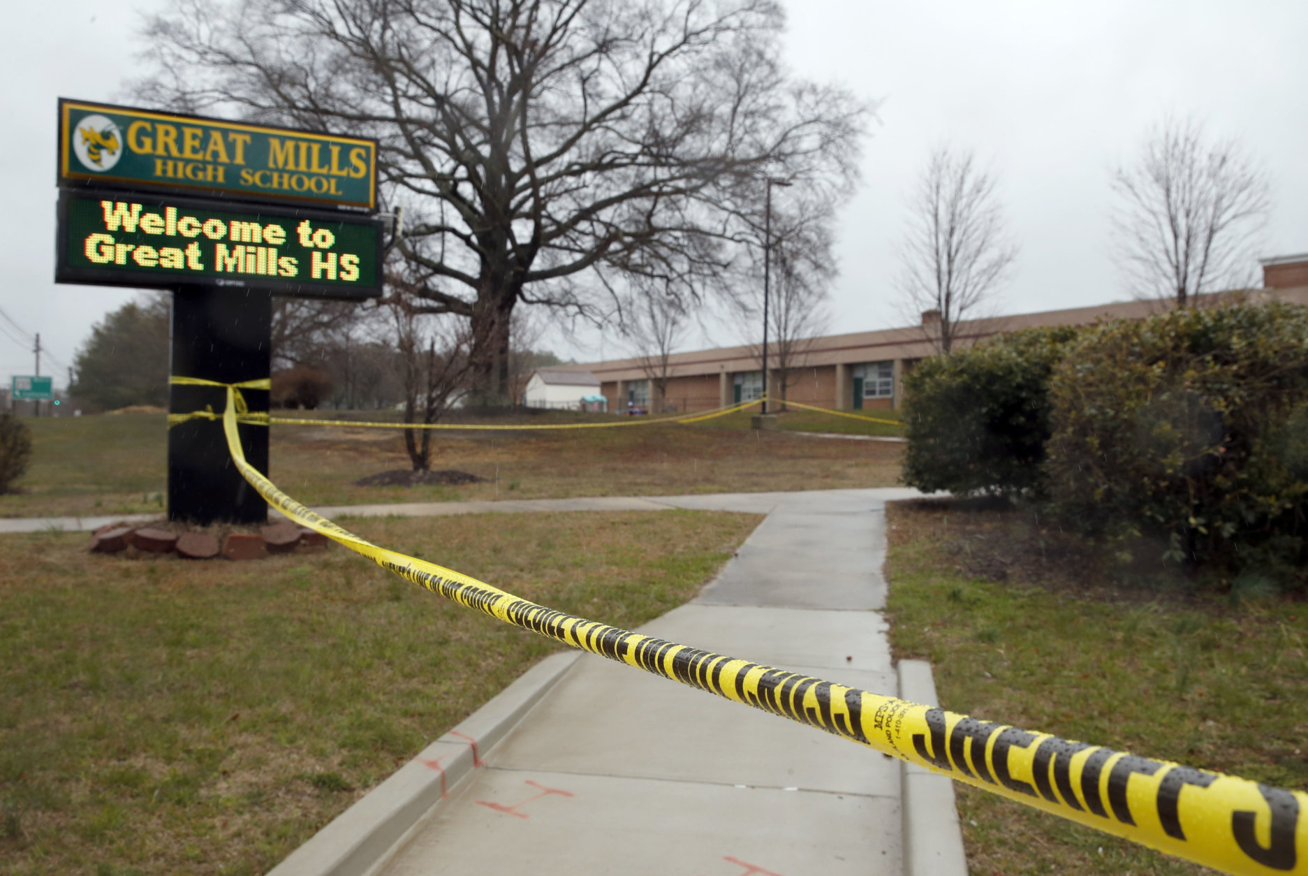Crime scene tape is used around Great Mills High School, the scene of a shooting, Tuesday, March 20, 2018, in Great Mills. A student with a handgun shot two classmates inside the school before he was fatally wounded during a confrontation with a school resource officer, a sheriff said.  (AP Photo/Alex Brandon)