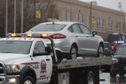 A car is towed away on a flatbed tow-truck away from Great Mills High School, the scene of a shooting, Tuesday, March 20, 2018, in Great Mills.  (AP Photo/Alex Brandon)