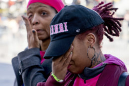Nicole Spriggs, left, and April Amarsh, right, cry as they arrive at the "March for Our Lives" rally in support of gun control in Washington, Saturday, March 24, 2018. They were among friends and family attending in memory of college bound Jamahri Sydnor, 17, who was shot to death in August 2017, in Washington. (AP Photo/Andrew Harnik)