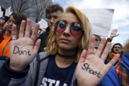 Daisy Hernandez, 22, of Stafford, Va., wrote "Don't Shoot," on her hands during the "March for Our Lives" rally in support of gun control, Saturday, March 24, 2018, in Washington. (AP Photo/Alex Brandon)