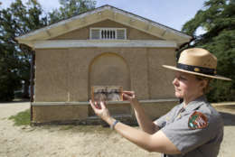 National Park Service Jennifer Mummart holds the photo of Selina Norris Gray, at the site where was taken at Arlington National Cemetery Thursday, Oct. 9, 2014, in Arlington, Va. Selina was in charge to care for Arlington House the Lee had lived in for 30 years, The photograph was in the auction site eBay. (AP Photo/Jose Luis Magana)